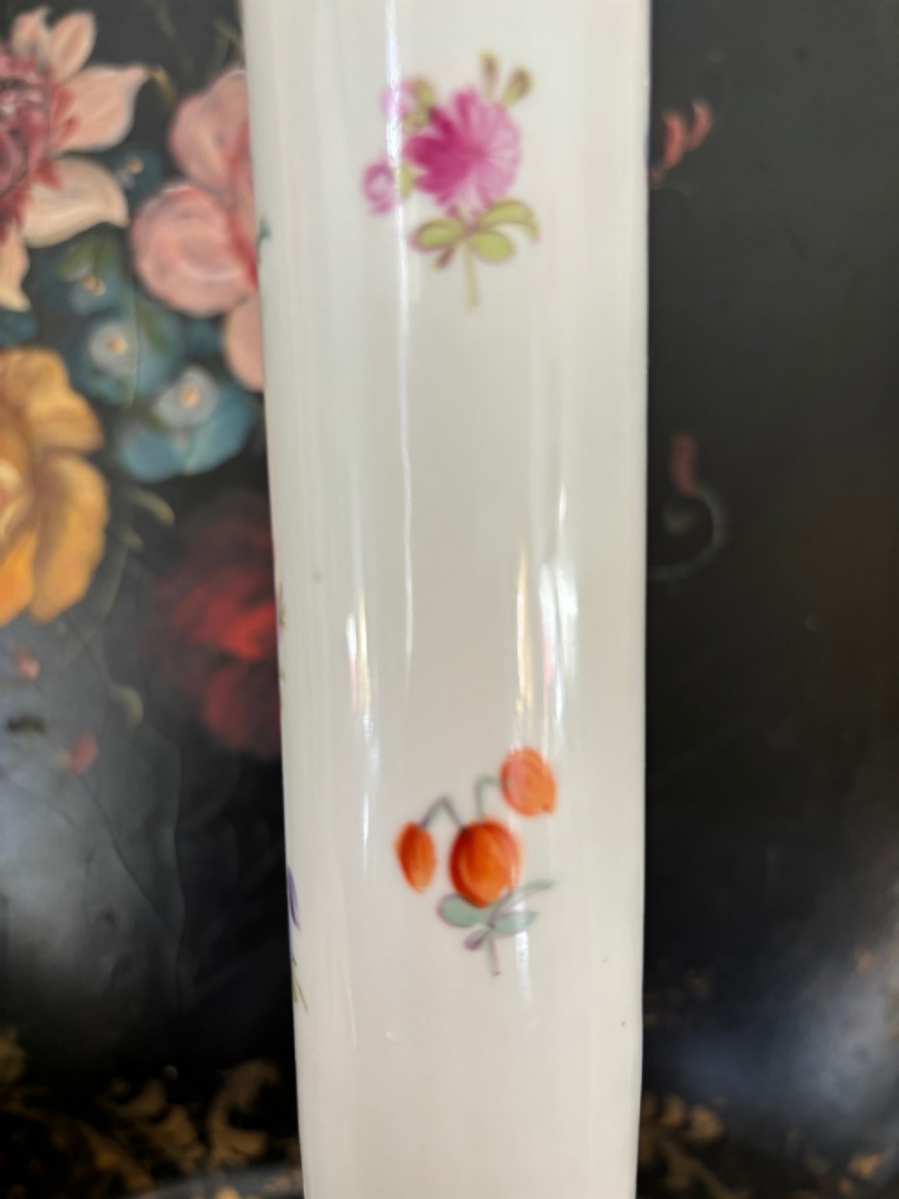 A pair of white 19th-century Sitzendorf porcelain covered vases featuring slender necks, bulbous bodies, hand-painted floral motifs, and gilded accents. View V