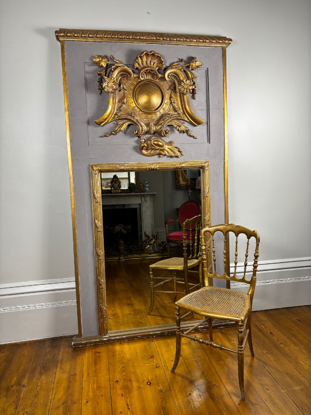 A 19th-century French giltwood salon chair featuring turned spindles, a woven cane seat, and slender curved legs with a distressed gold finish. View II