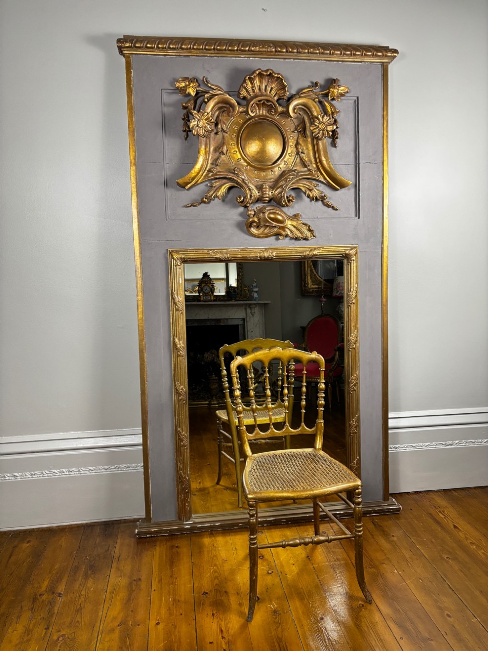 A 19th-century French giltwood salon chair featuring turned spindles, a woven cane seat, and slender curved legs with a distressed gold finish. View III