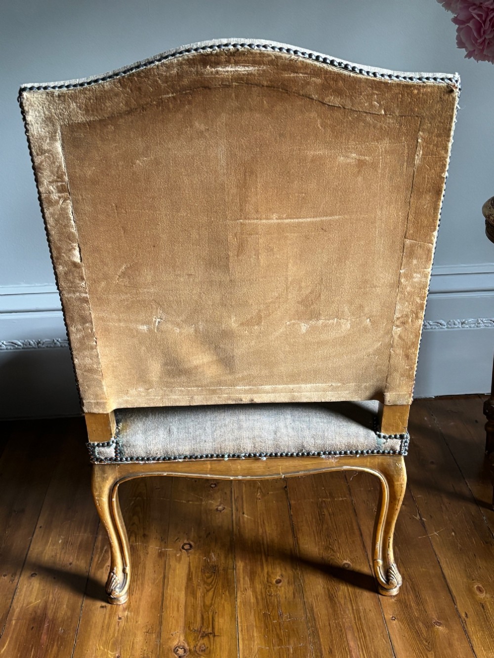 A late 19th-century French Regence style giltwood open armchair featuring carved scrollwork arms, cabriole legs, and floral tapestry upholstery. View IX
