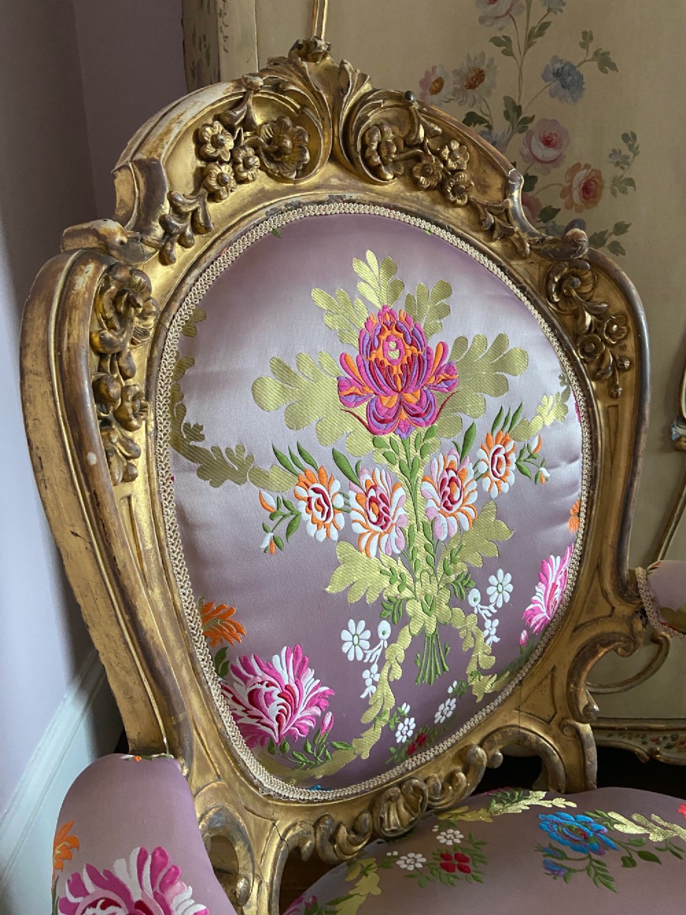 A 19th-century Rococo Revival open armchair with a carved giltwood frame and pink floral silk upholstery. View VI