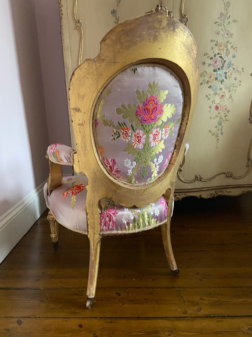 A 19th-century Rococo Revival open armchair with a carved giltwood frame and pink floral silk upholstery. View VII