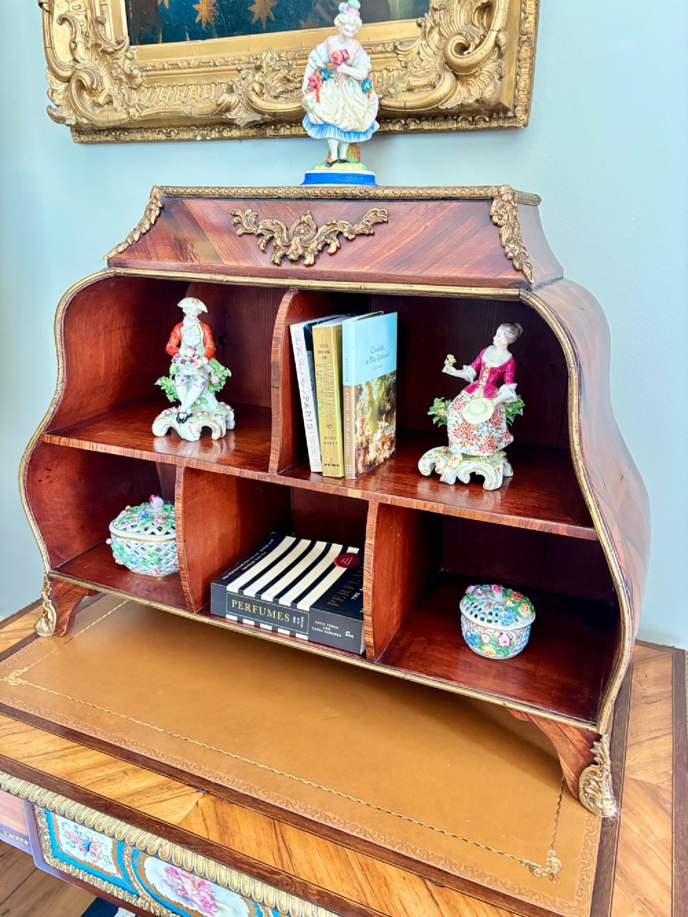 A Louis XV style rosewood desktop cartonnier featuring open compartmentalised shelves and gilded ormolu mounts along the crest and feet. View VII
