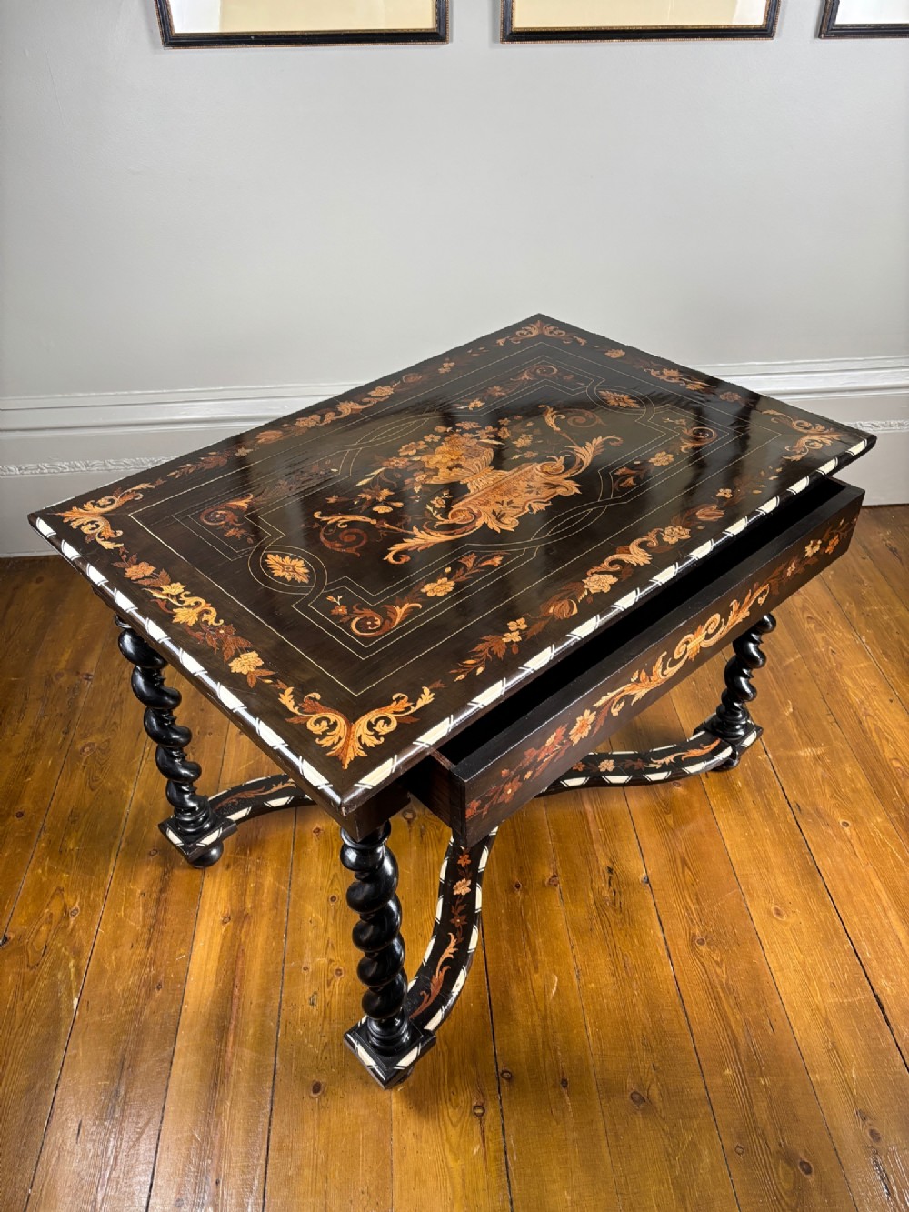 A 19th-century Dutch ebonised rectangular table featuring detailed floral marquetry, bone inlay edging, barley twist legs, and an X-frame stretcher. View VII