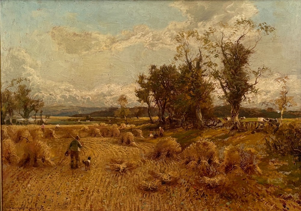 A Victorian landscape oil painting depicting a harvest field with haystacks and a figure, enclosed in an ornate gilded frame with a velvet slip. View VII