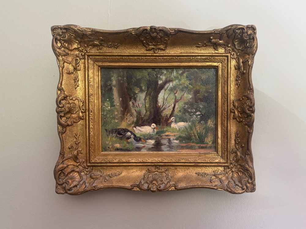 An oil painting on canvas depicting three ducks at a woodland pool, housed within an ornate carved giltwood frame.