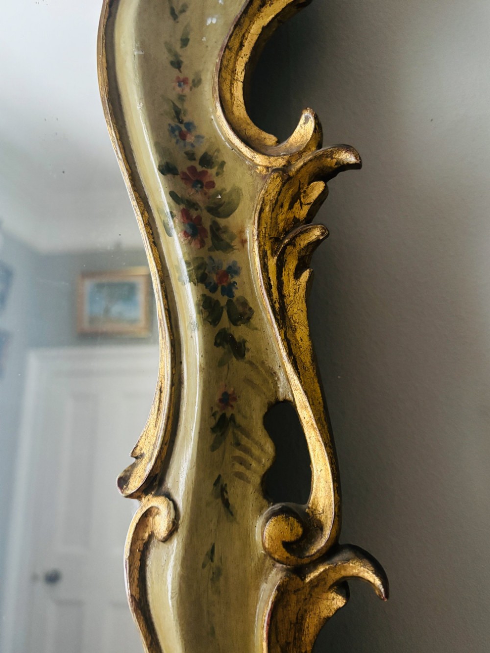 A mid-19th century Italian Venetian wall mirror featuring a carved giltwood frame with scrolling cresting, a sage green polychrome finish, and hand-painted floral detail. View III