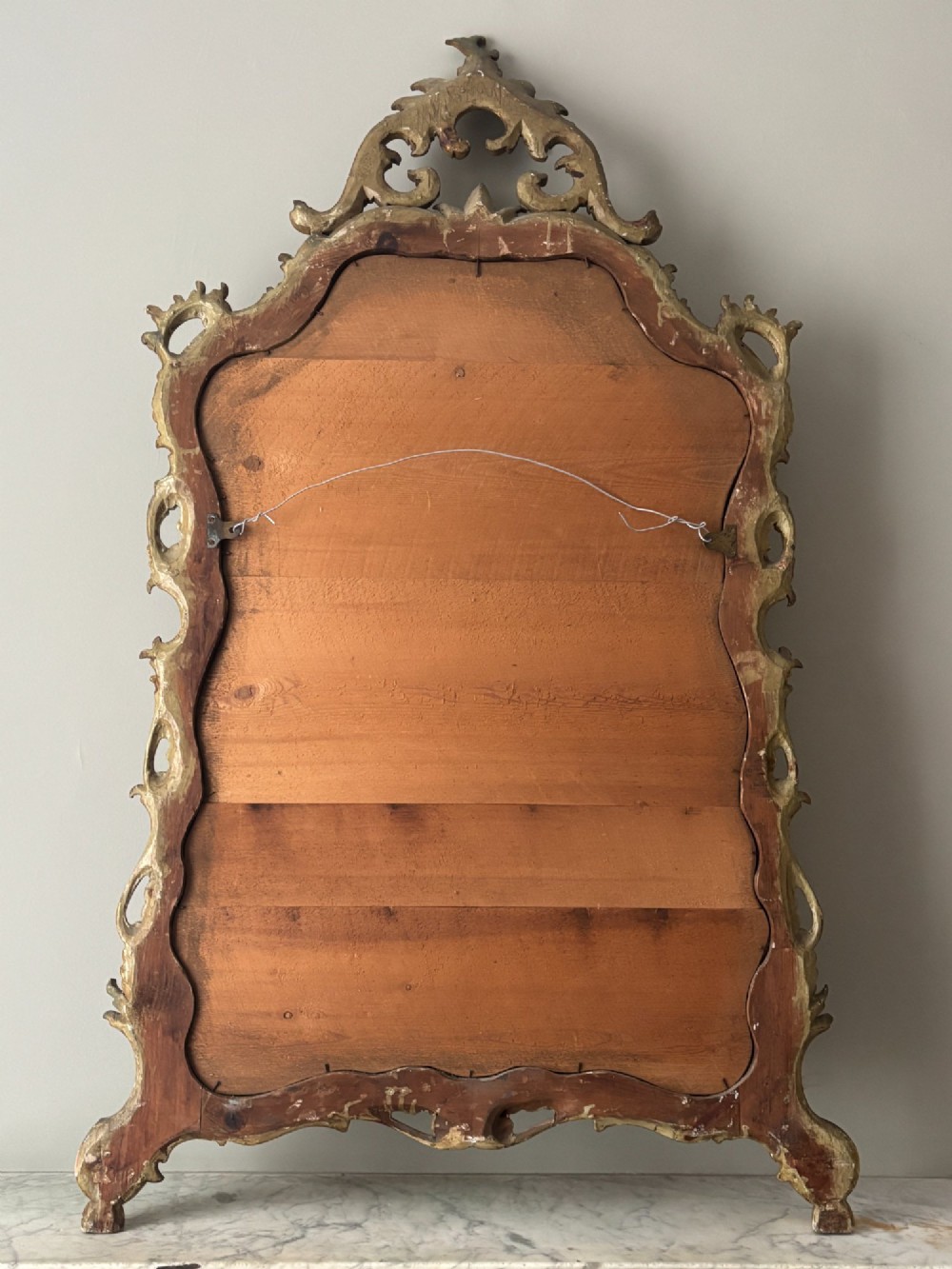 A mid-19th century Italian Venetian wall mirror featuring a carved giltwood frame with scrolling cresting, a sage green polychrome finish, and hand-painted floral detail. View IX