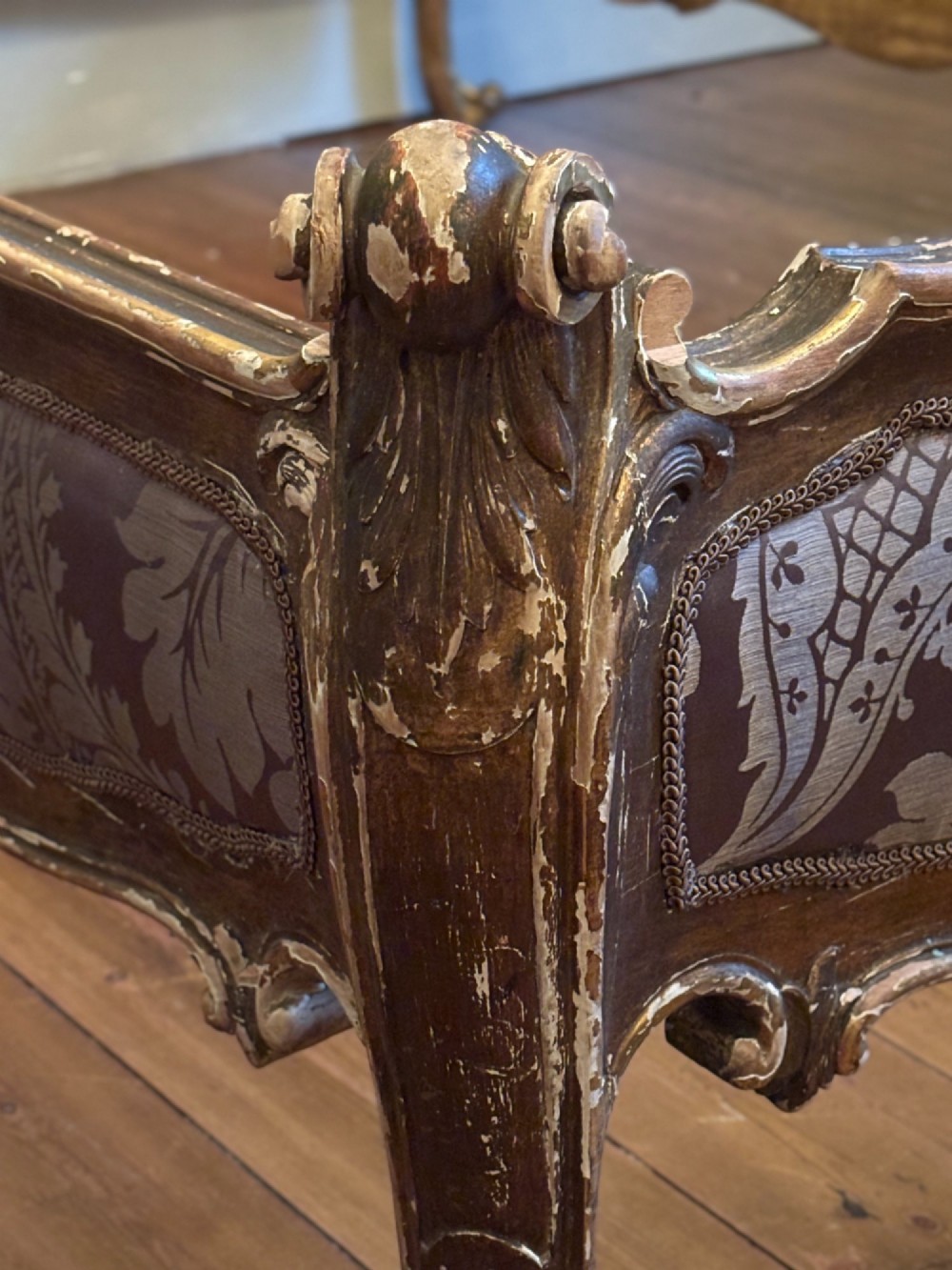 An Italian 19th-century Rococo style giltwood bed with shell crest carvings and purple floral damask upholstery on the headboard and footboard. View V