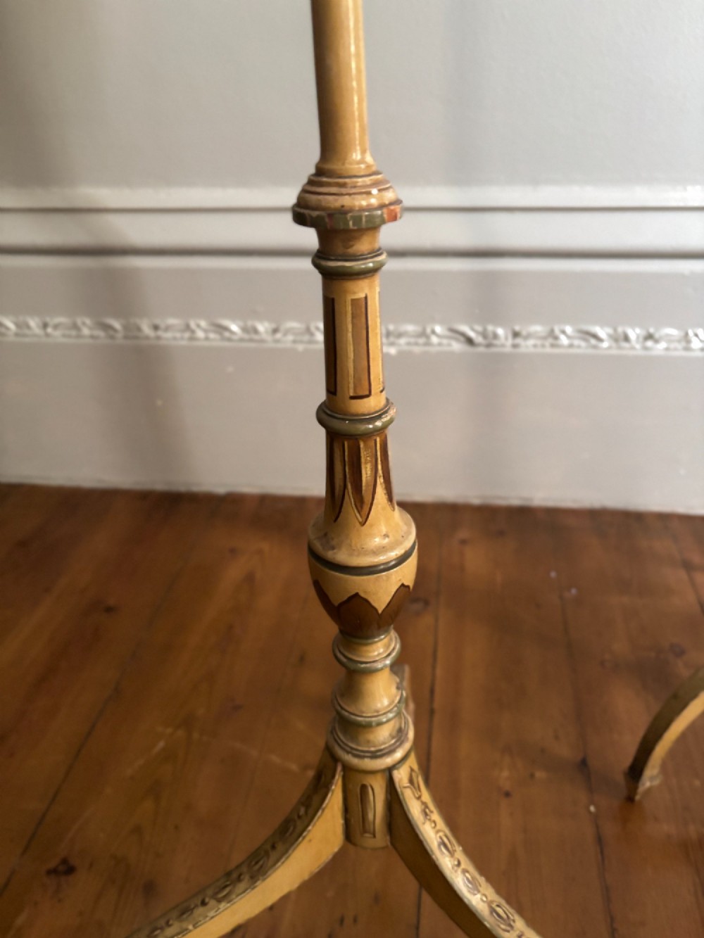 A pair of antique Georgian cream-painted wooden pole screens featuring hand-painted classical figures on shaped panels supported by tripod bases with spade feet. View V