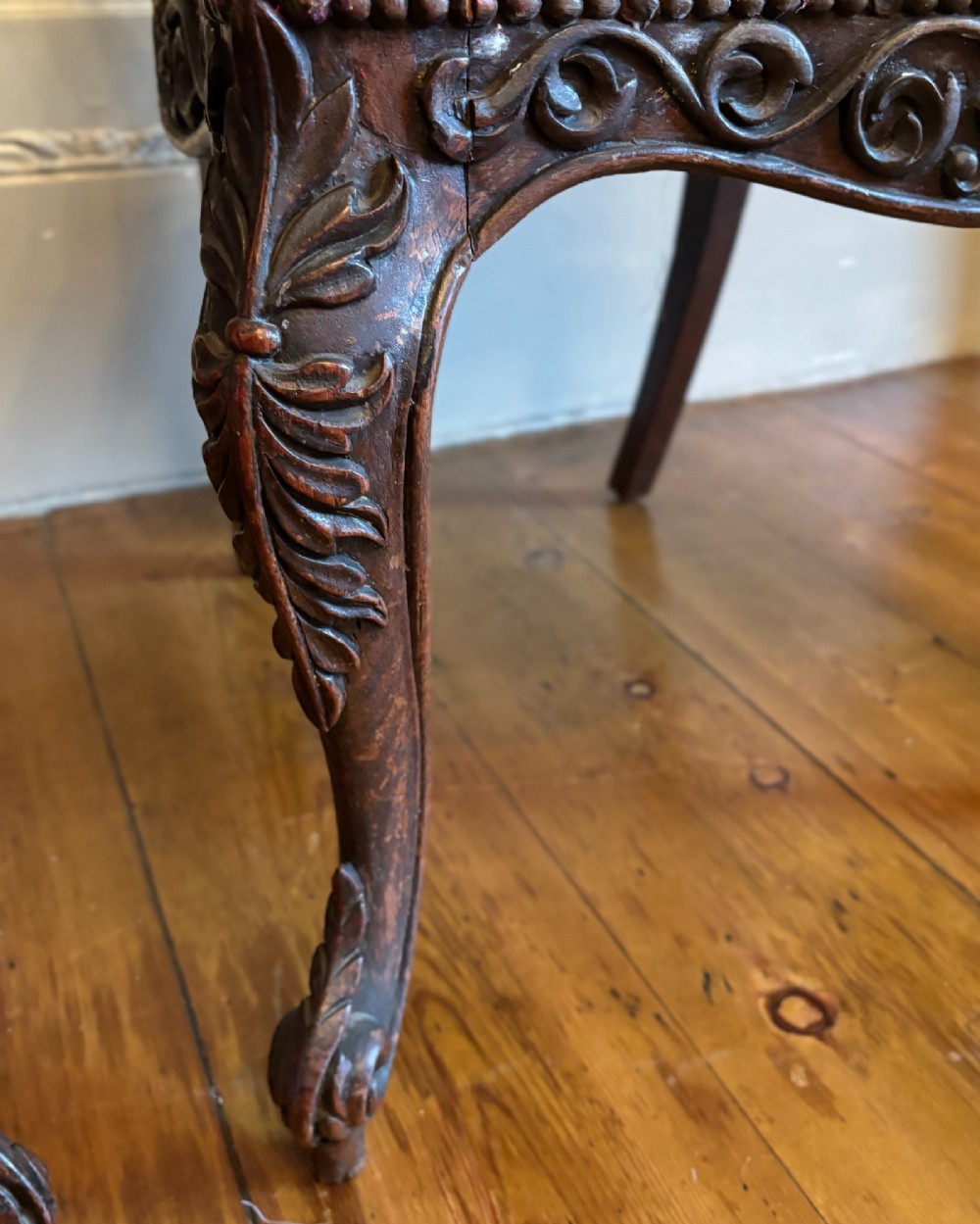 A pair of 19th century Anglo-Indian padauk side chairs with intricately carved openwork foliate backs, cabriole legs, and pink silk upholstery. View IV