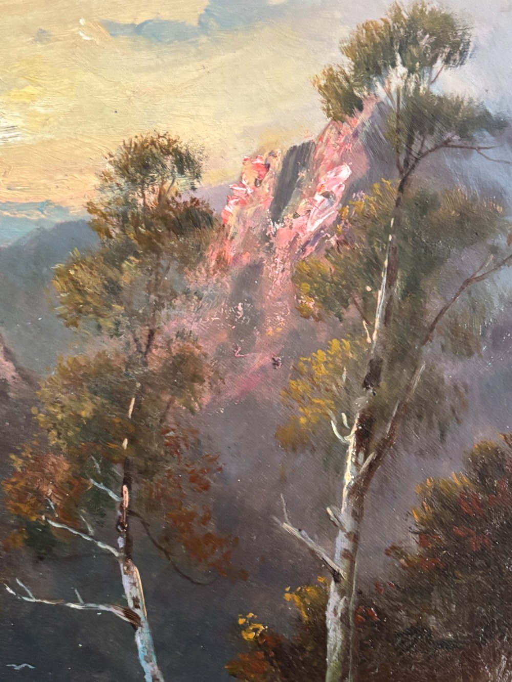 A vertical oil painting depicting a flock of sheep and a dog walking through a mountainous valley path at sunset, framed in an ornate gilded frame. View VI