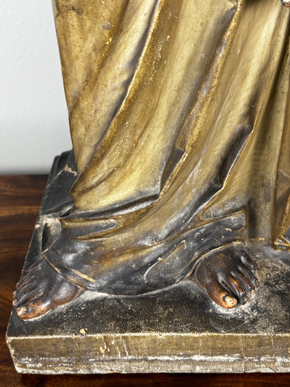 A 19th-century carved Italian wooden angel statue with gold wings, painted drapery in muted blue and ochre tones, and hands resting across its chest. View IV
