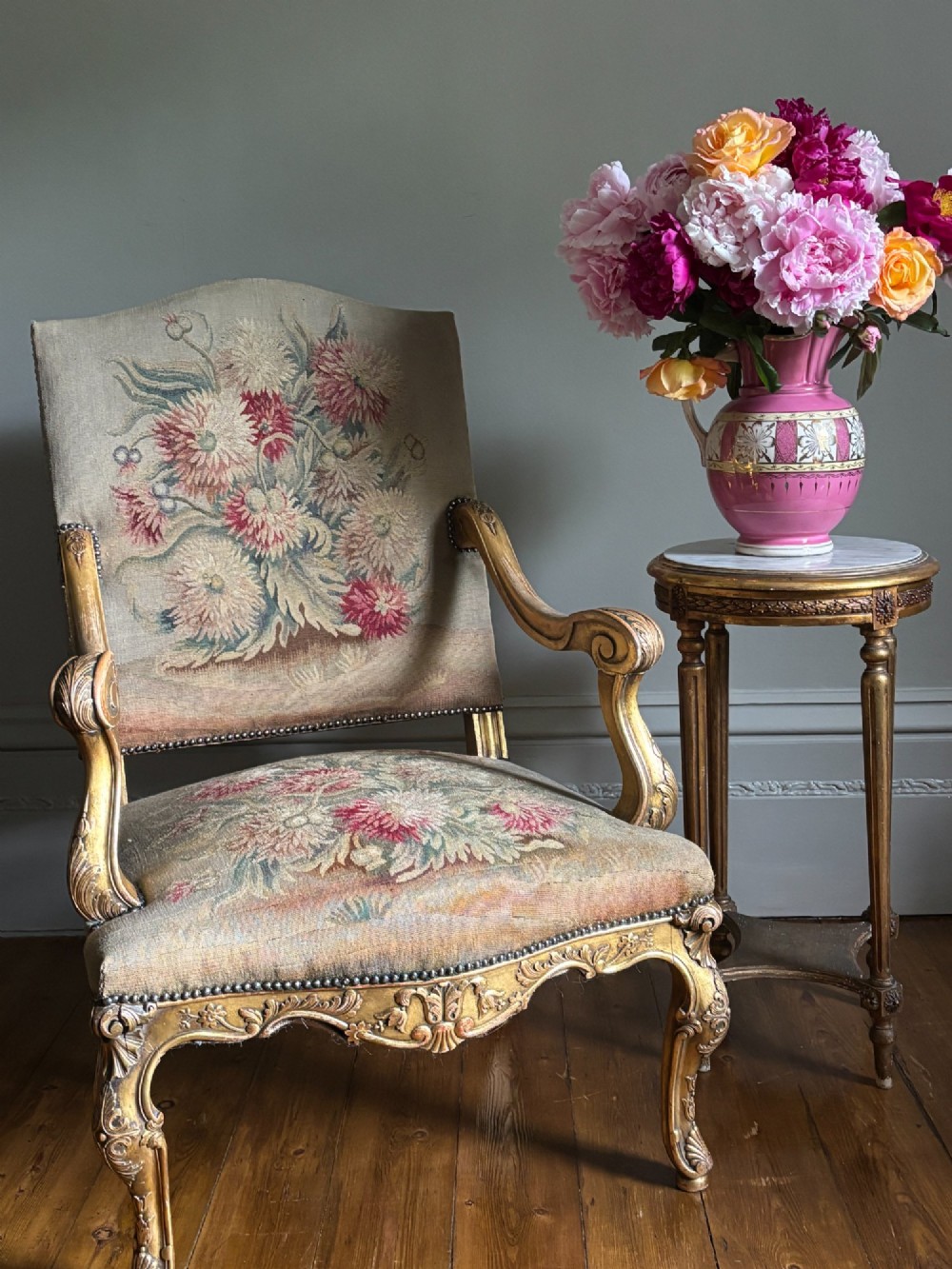 A late nineteenth-century French Regence style giltwood open armchair featuring floral tapestry upholstery and carved cabriole legs. View III
