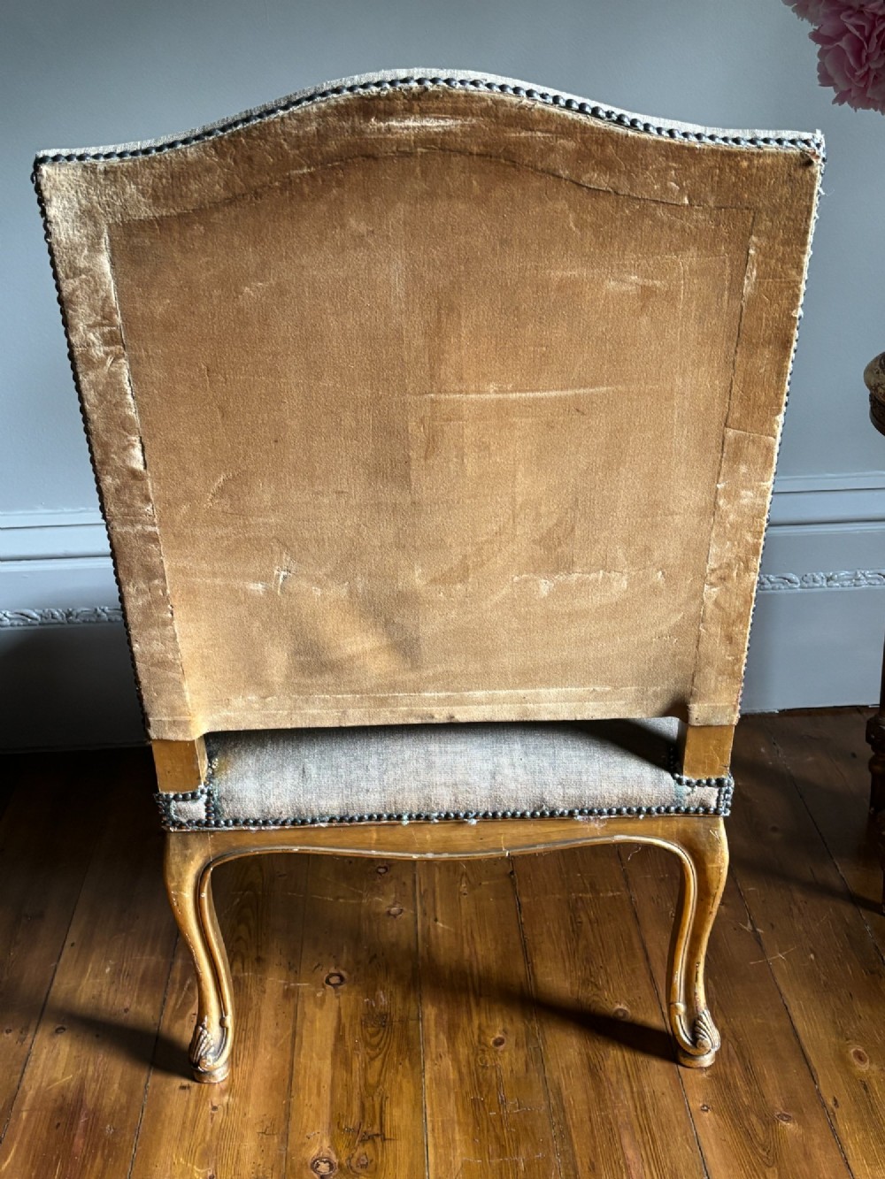 A late nineteenth-century French Regence style giltwood open armchair featuring floral tapestry upholstery and carved cabriole legs. View XI