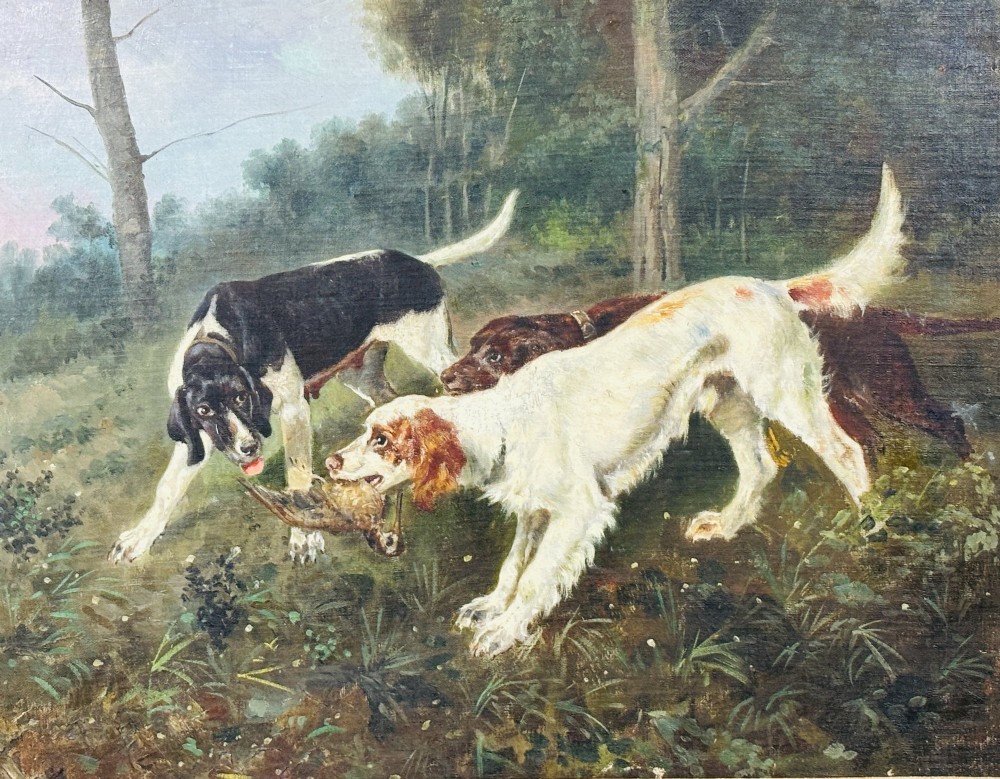 A framed oil painting on canvas depicting hunting dogs retrieving a game bird in a woodland clearing. View III