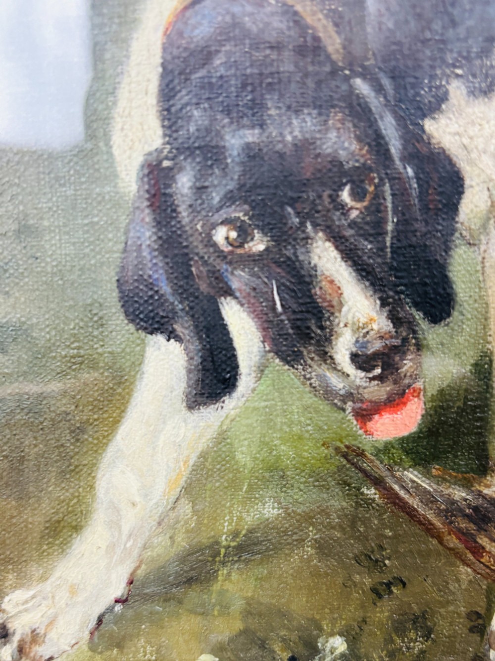 A framed oil painting on canvas depicting hunting dogs retrieving a game bird in a woodland clearing. View V