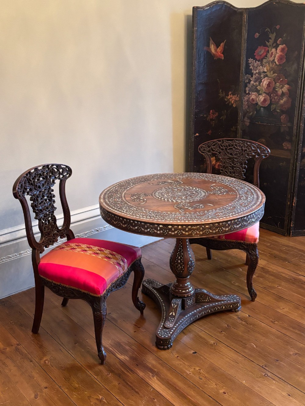 A 19th-century circular Anglo-Indian pedestal table made of dark hardwood with geometric mother-of-pearl inlay across the top, apron, turned column, and tripod base. View III