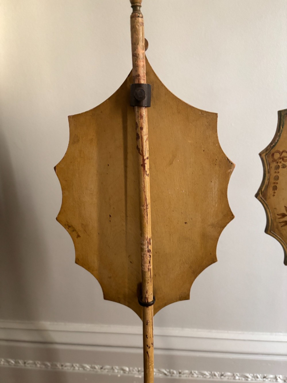 A pair of antique Georgian yellow painted pole screens featuring oval painted classical figurative vignettes and tripod bases with spade feet. View VII