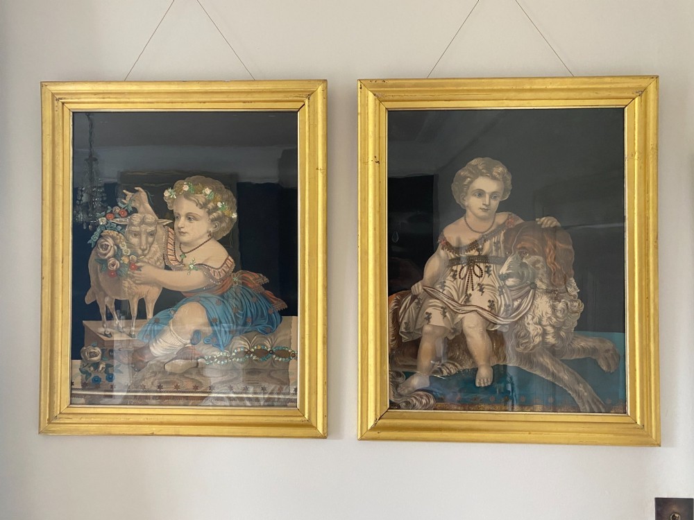 A pair of gilt-framed circa 1820 prints depicting young children with animals against dark backgrounds with metallic clothing embellishments. View II