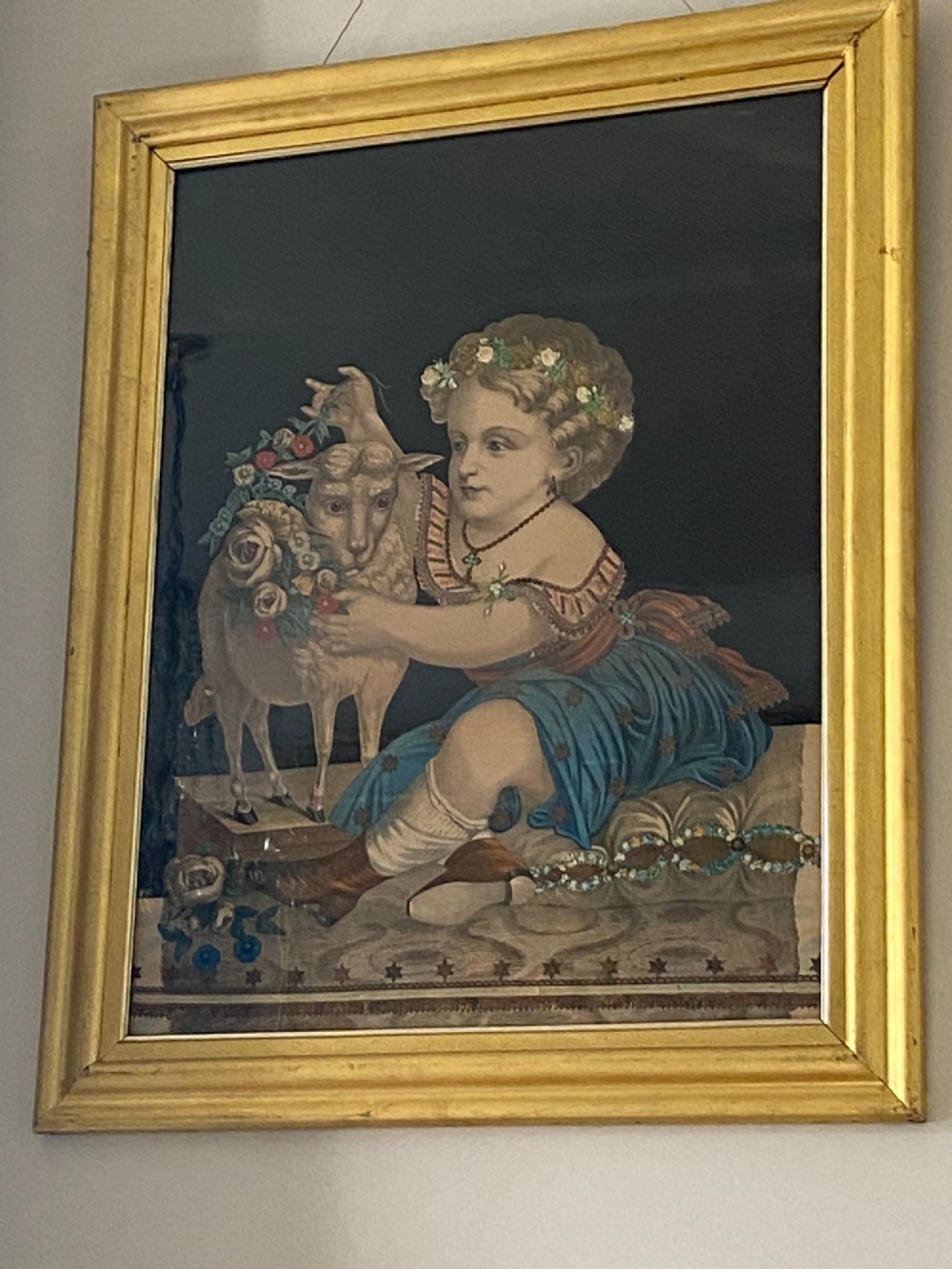 A pair of gilt-framed circa 1820 prints depicting young children with animals against dark backgrounds with metallic clothing embellishments. View V