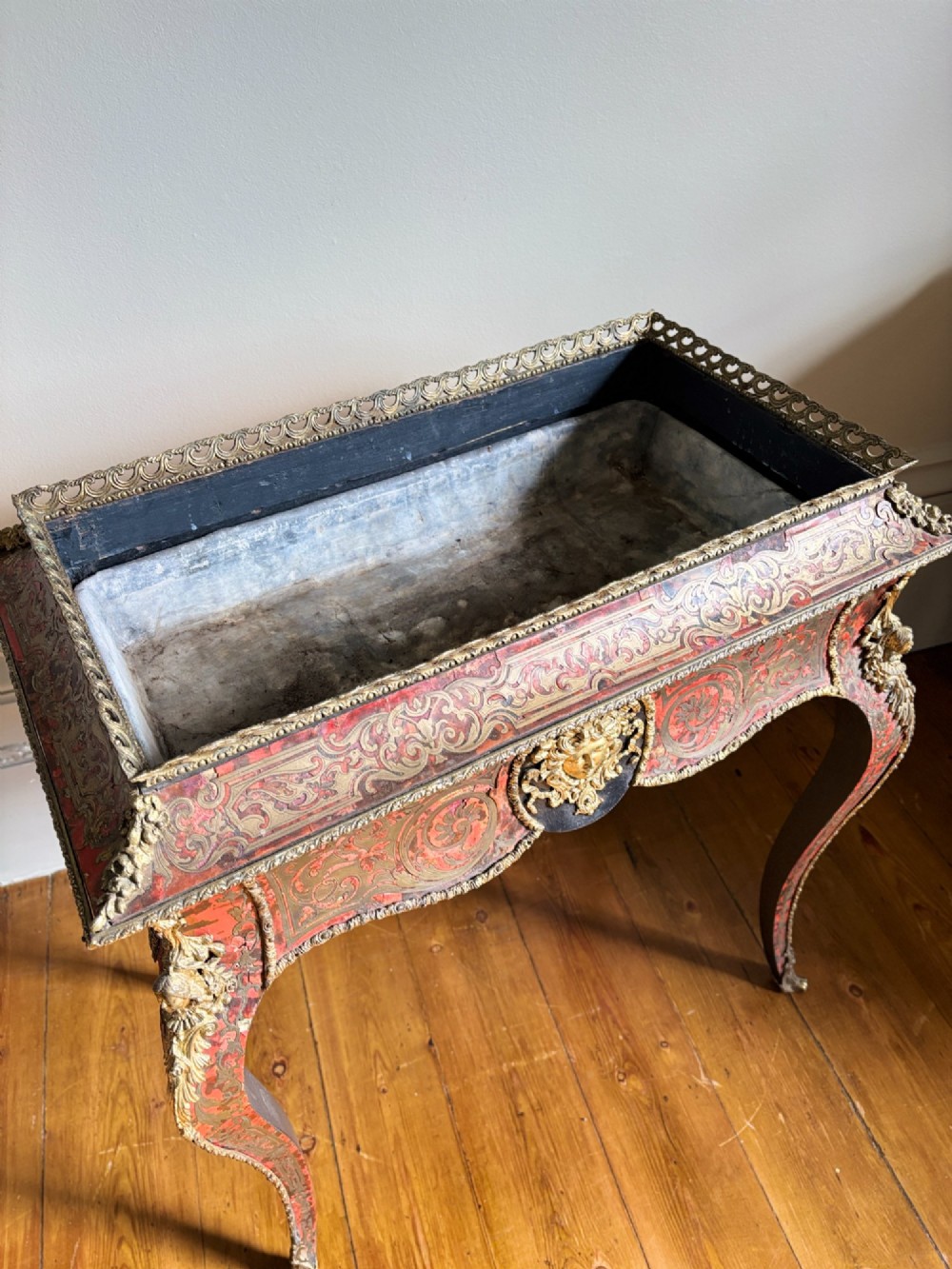 A 19th-century French Napoleon III jardiniere stand featuring red tortoiseshell and brass Boulle marquetry, ormolu mounts, and cabriole legs. View III