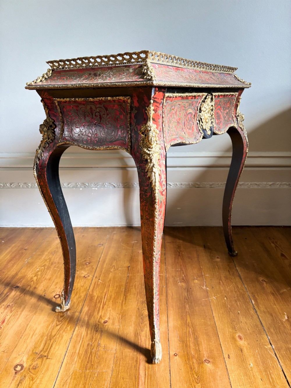 A 19th-century French Napoleon III jardiniere stand featuring red tortoiseshell and brass Boulle marquetry, ormolu mounts, and cabriole legs. View VIII