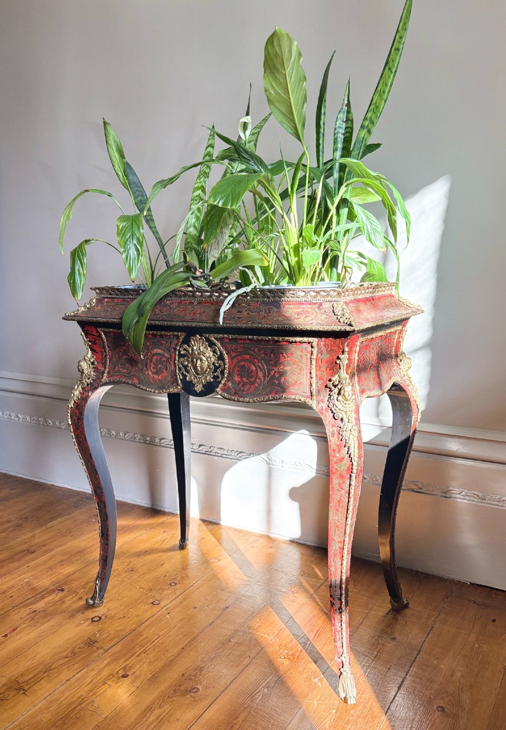 A 19th-century French Napoleon III jardiniere stand featuring red tortoiseshell and brass Boulle marquetry, ormolu mounts, and cabriole legs. View XIII