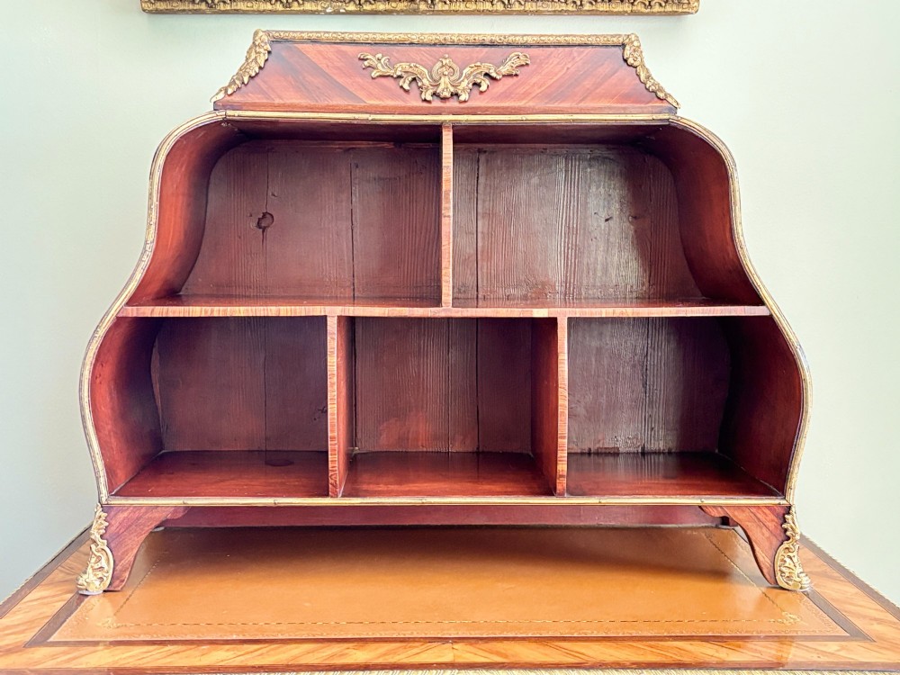A nineteenth-century French Louis XV style rosewood desktop cartonnier with multiple open pigeonhole compartments and carved gilt-bronze ormolu mounts. View VI