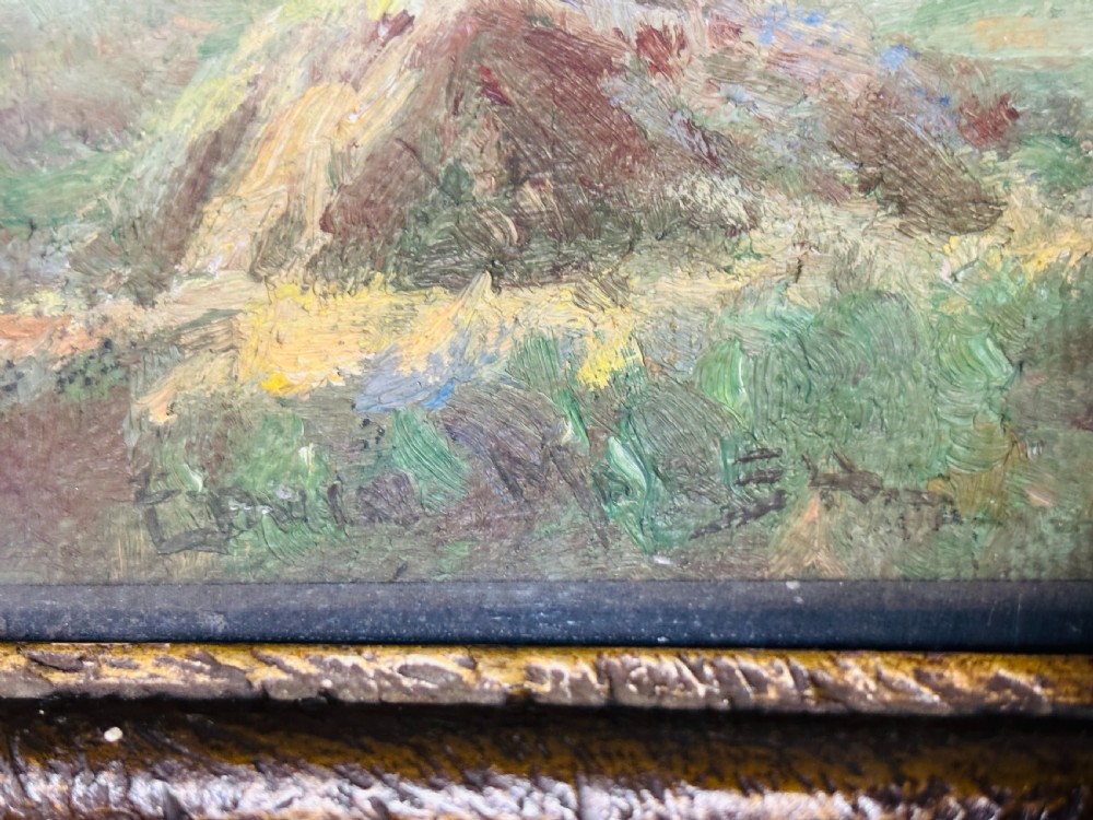 An Edwardian oil painting on board depicting a rural landscape with haystacks, cottages, and clouds set within a moulded frame. View VI
