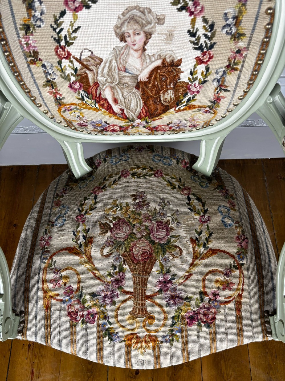 An 18th-century style pale green painted open armchair featuring an oval backrest and seat upholstered in petit point tapestry depicting floral and figural motifs. View III