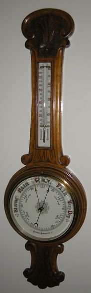 A Carved Oak Victorian Aneroid Barometer
