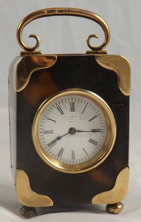 A Tortoiseshell Miniature Carriage Clock with 9 Ct Gold Mounts and Handle