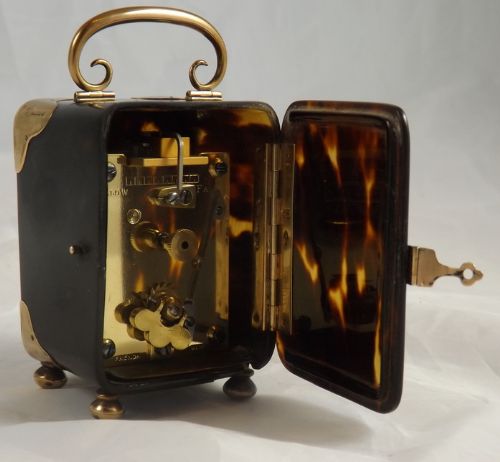 fig 1. A tortoiseshell miniature carriage clock with 9 ct gold mounts and handle