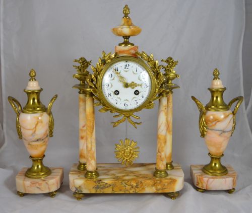 A Marble Portico Clock with Matching Side Garnitures