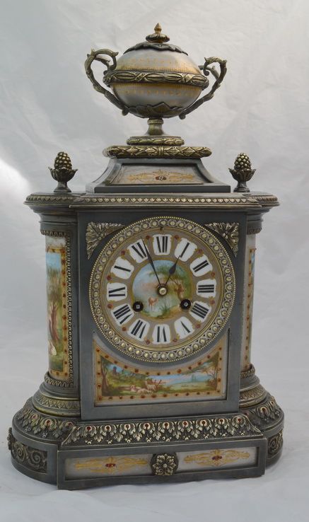 A Silvered Bronze Porcelain Panelled Mantle Clock