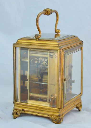 fig 1. A Gilt Carriage Clock Under Its Original Glass Dome