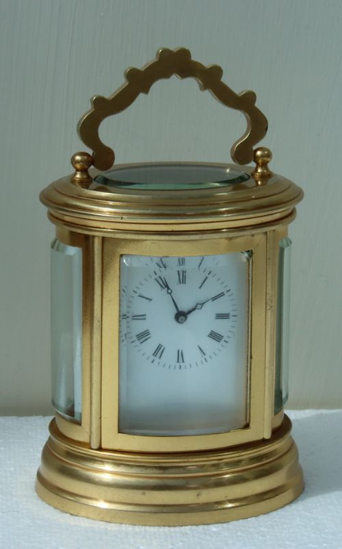 A Miniature Oval Carriage Clock