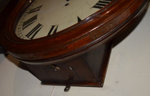 fig 1. A circular Victorian wall clock featuring a moulded dark mahogany wooden surround and a cream dial with black Roman numerals.