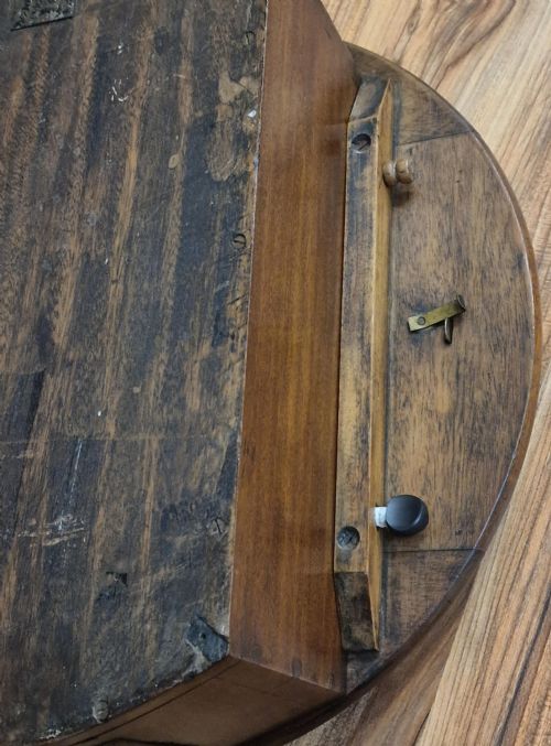 fig 1. A circular mahogany wall clock featuring a brass bezel around an off-white dial with black Roman numerals and an RAF insignia.