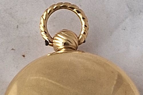 fig 1. A Georgian gilt verge fusee pocket watch featuring a white enamel dial with Roman numerals and a textured twisted suspension loop.