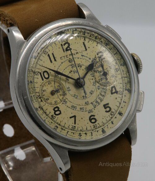 fig 1. A vintage 1930s Eterna chronograph wristwatch with a patinated cream dial, two sub-dials, stainless steel case, and brown leather strap.