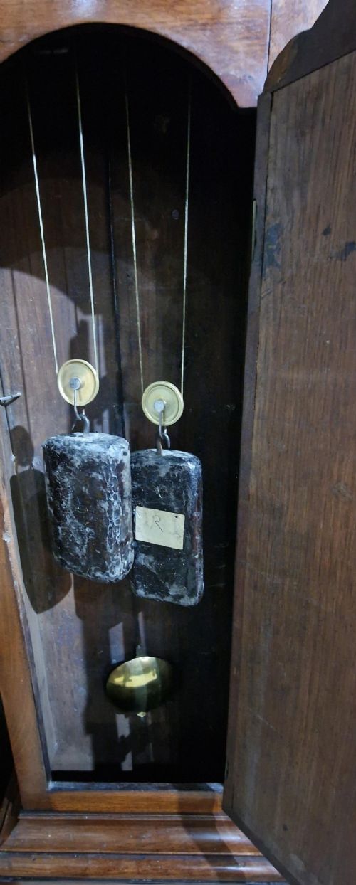 A Georgian mahogany grandmother clock featuring a swan-neck pediment, brass rosettes, an engraved brass and silvered dial, and an inlaid wooden trunk case. View IX