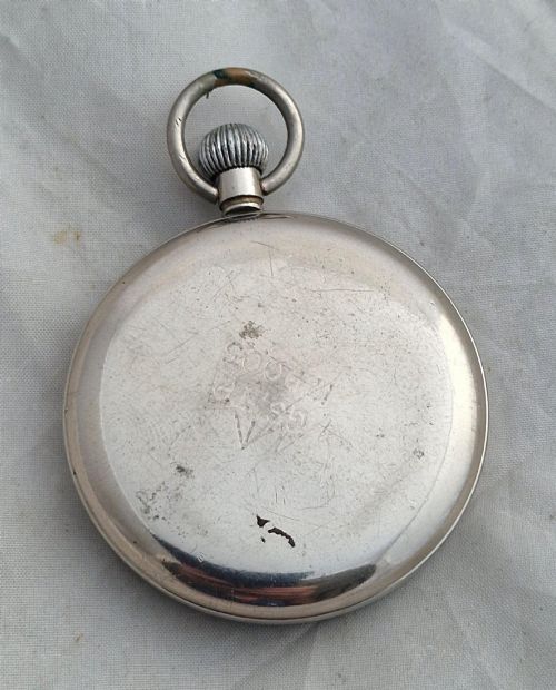 fig 1. A Second World War Helvetia military pocket watch featuring a black dial with luminous Arabic numerals and a silver-toned metal case.
