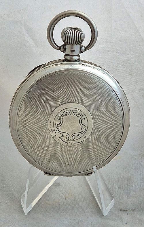 fig 1. An open-face silver Buren pocket watch featuring a white enamel dial with Roman numerals and a small seconds sub-dial.