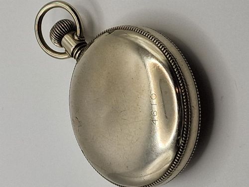fig 1. An open-face vintage military pocket watch featuring a black dial, Arabic numerals, luminous hands, a subsidiary seconds sub-dial, and a nickel case with top loop.