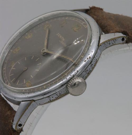 fig 2. A 1950s Zenith Sporto mechanical wristwatch featuring a grey dial, Arabic numeral hour markers, a sub-seconds dial, and a brown leather strap.