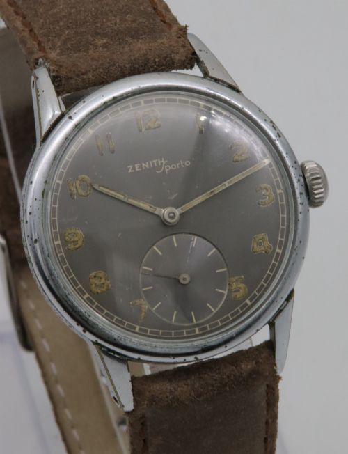 fig 3. A 1950s Zenith Sporto mechanical wristwatch featuring a grey dial, Arabic numeral hour markers, a sub-seconds dial, and a brown leather strap.
