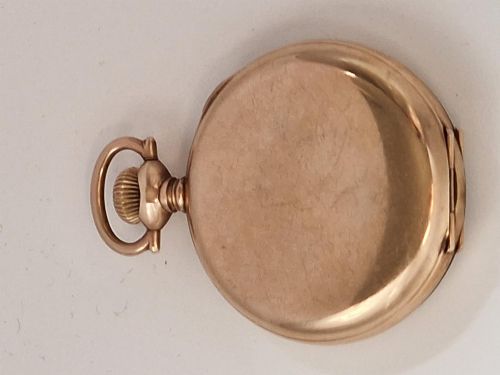 fig 1. An antique gold-toned open-face pocket watch featuring a white enamel dial with black Roman numerals, blued steel hands, and a sub-seconds dial.