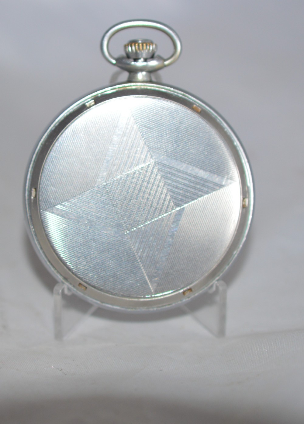 A slim silver-toned open-face Zenith pocket watch featuring a cream dial with Arabic numerals, gold-toned hands, and a small seconds sub-dial at six oclock. View III